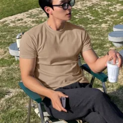 A high-quality beige men's plain t-shirt in a Korean-inspired style.