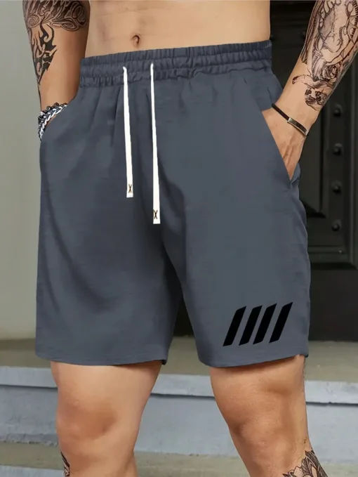 A man wearing a pair of charcoal grey men's athletic shorts with a black stripe graphic on the leg.